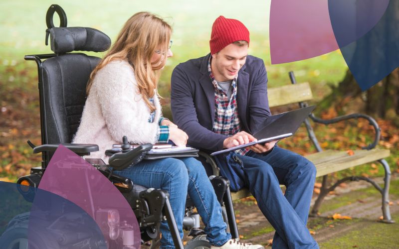 A provider and participant on a bench reviewing a document together.