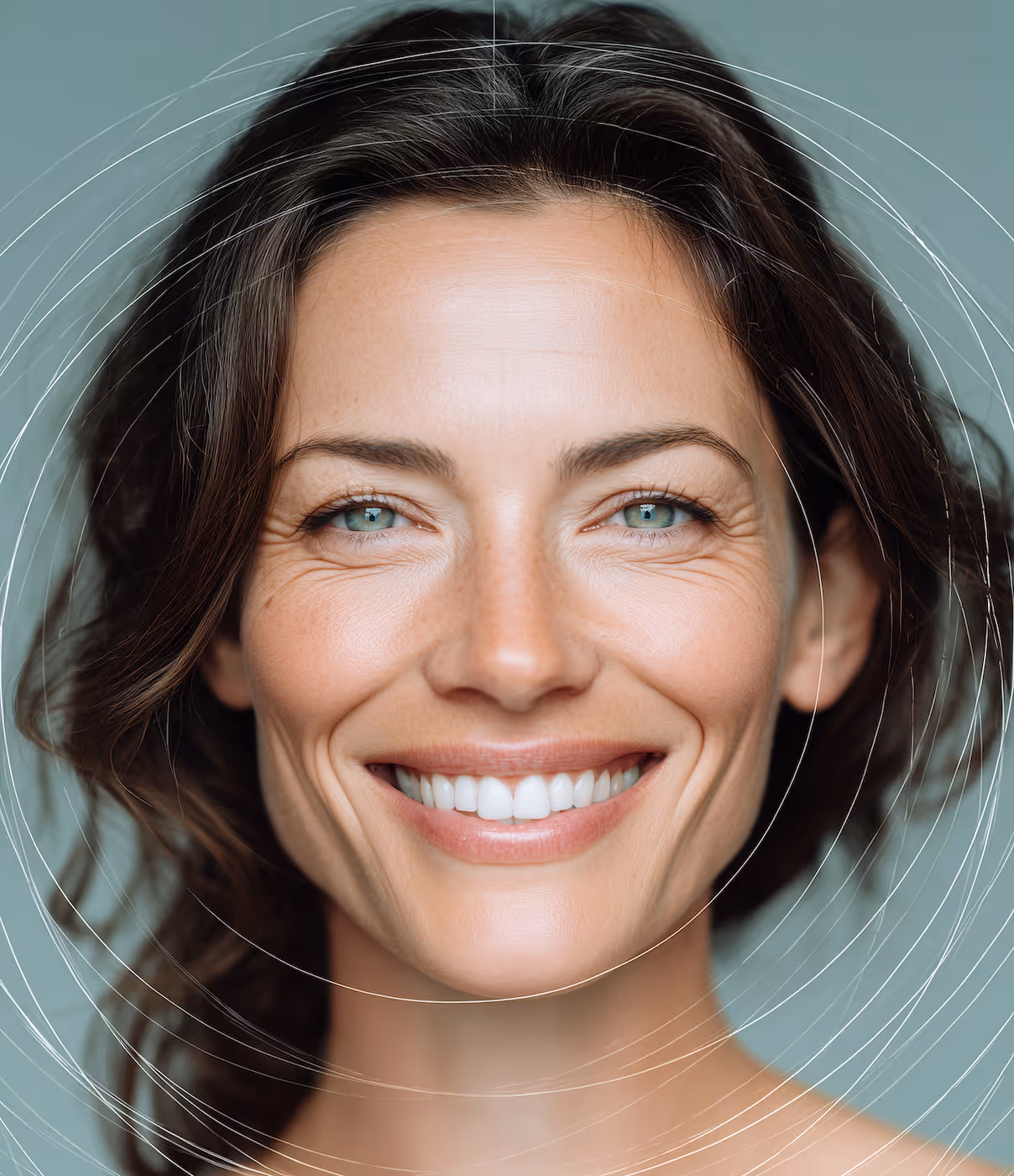 Close-up portrait of a smiling woman with green eyes and wavy brown hair against a teal background with white circular lines overlay.