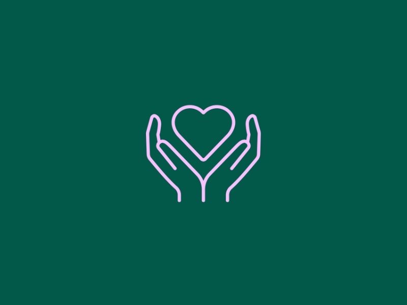 Two hands gently holding a heart icon on a dark green background.