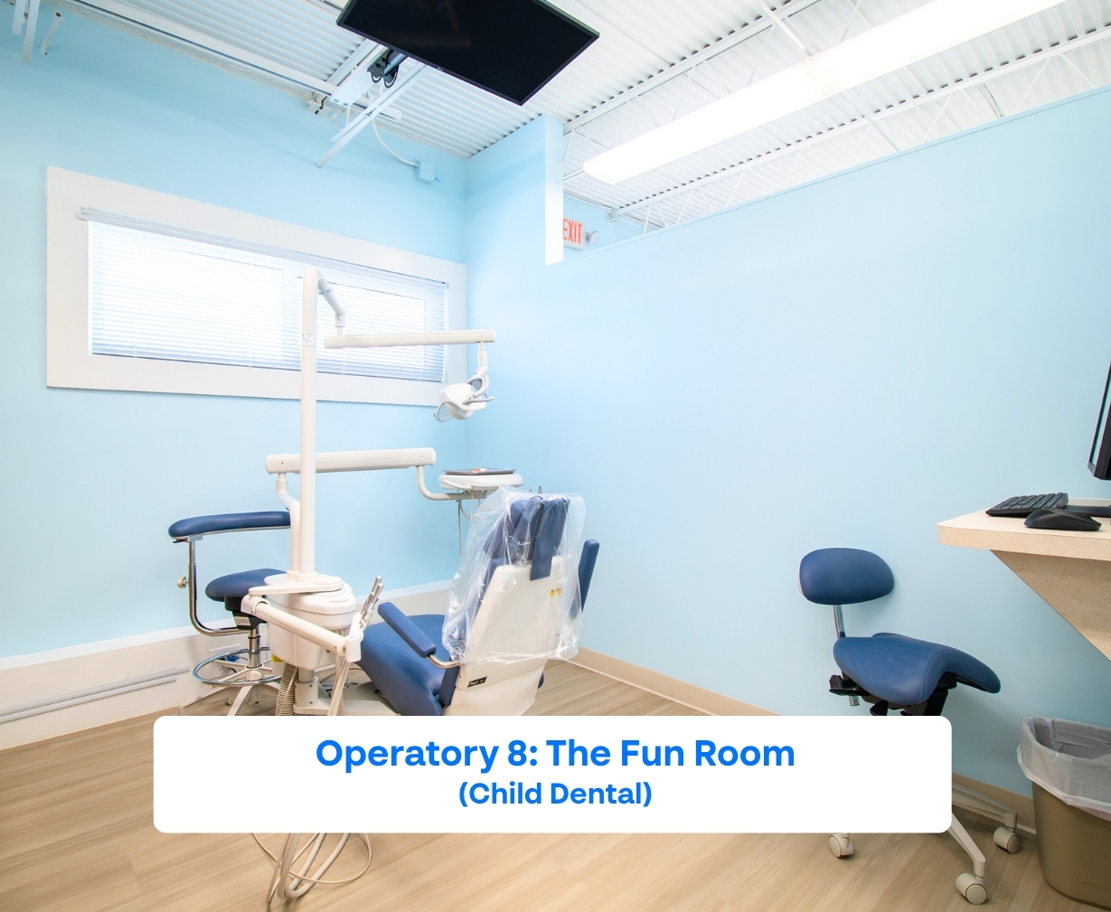 Pediatric dental operatory with dental chair, stools, dental equipment, and light blue walls.