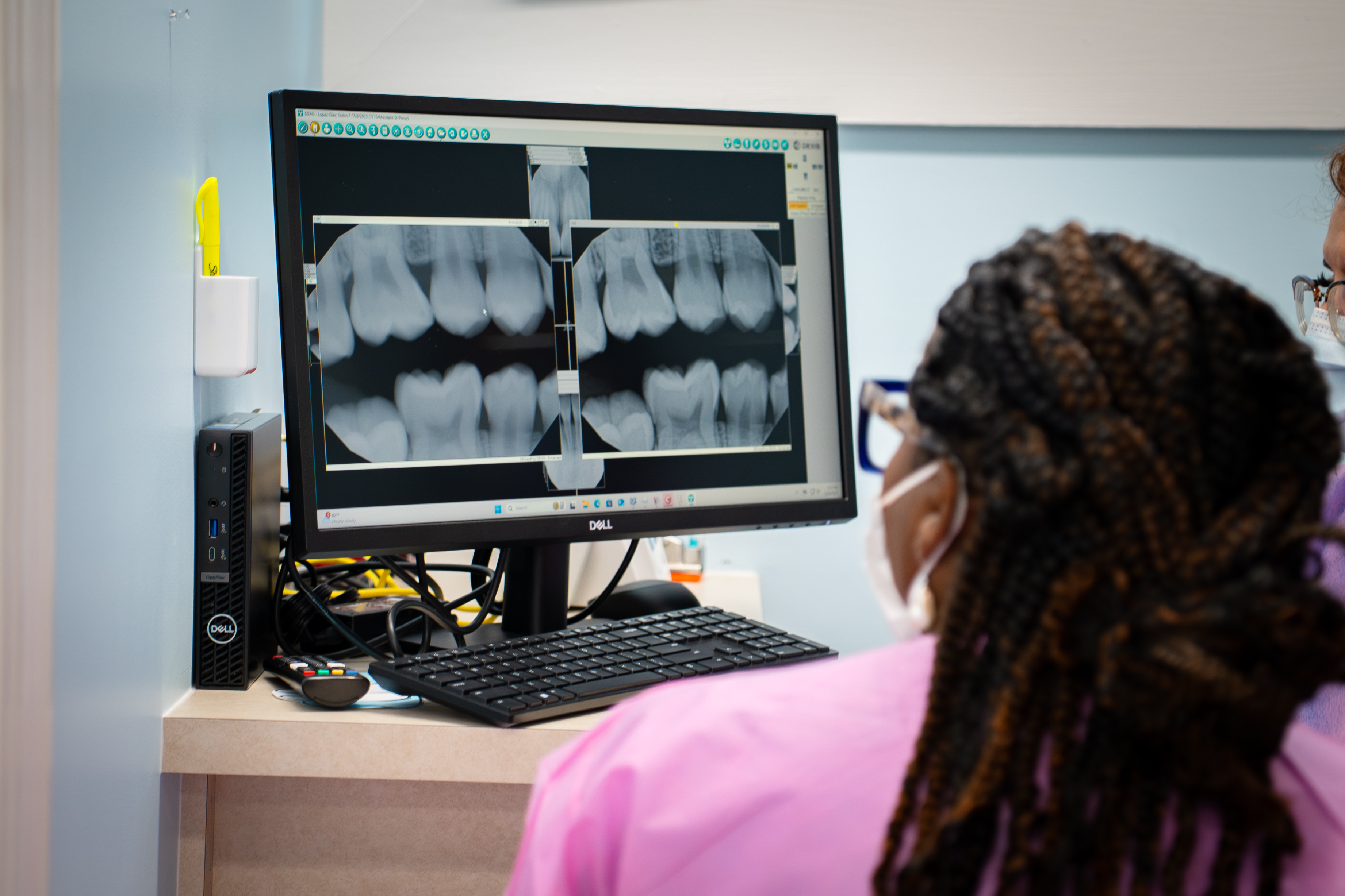 dentist looking at scan on computer