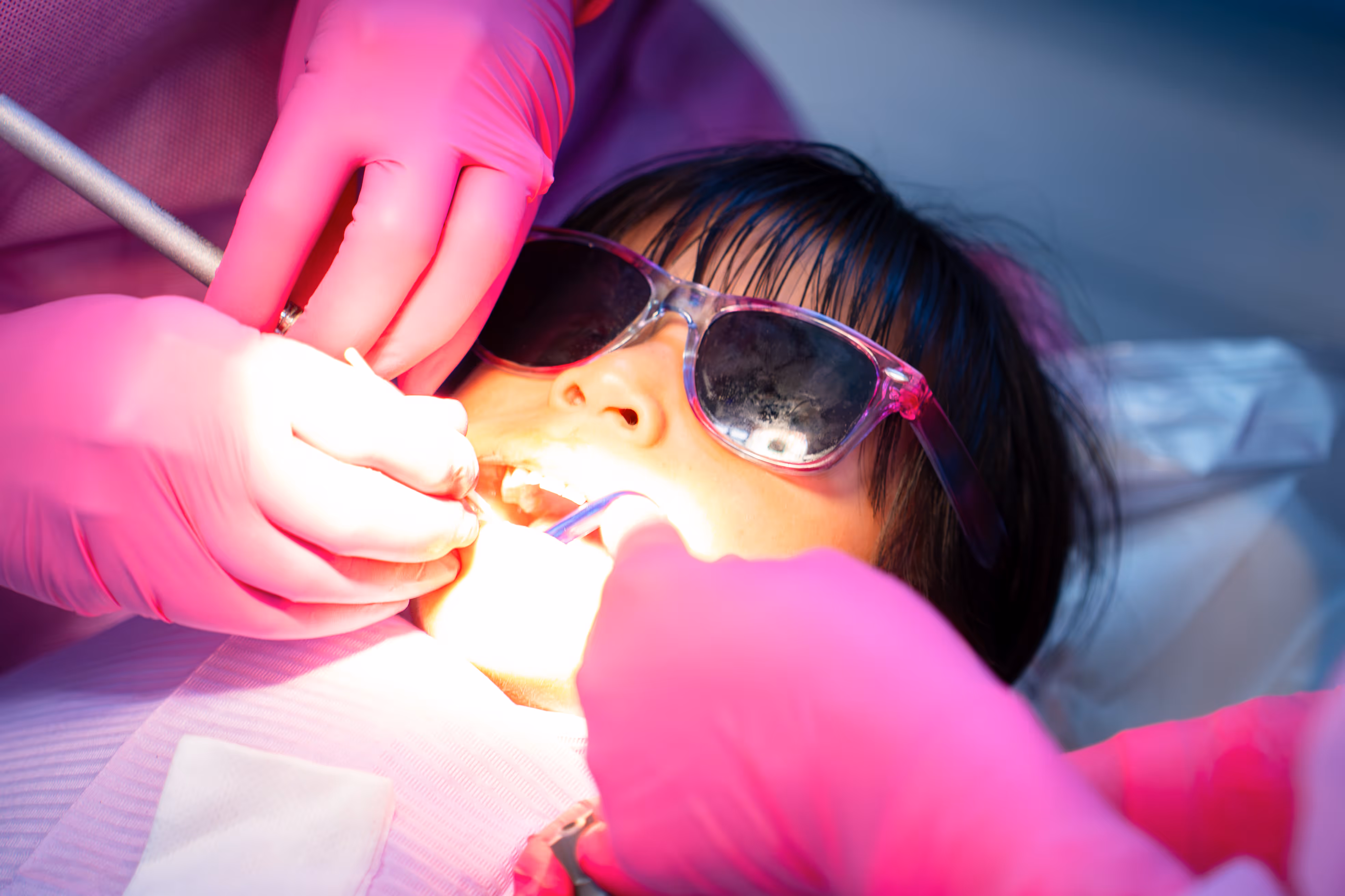 girl with sunglasses in dental chair
