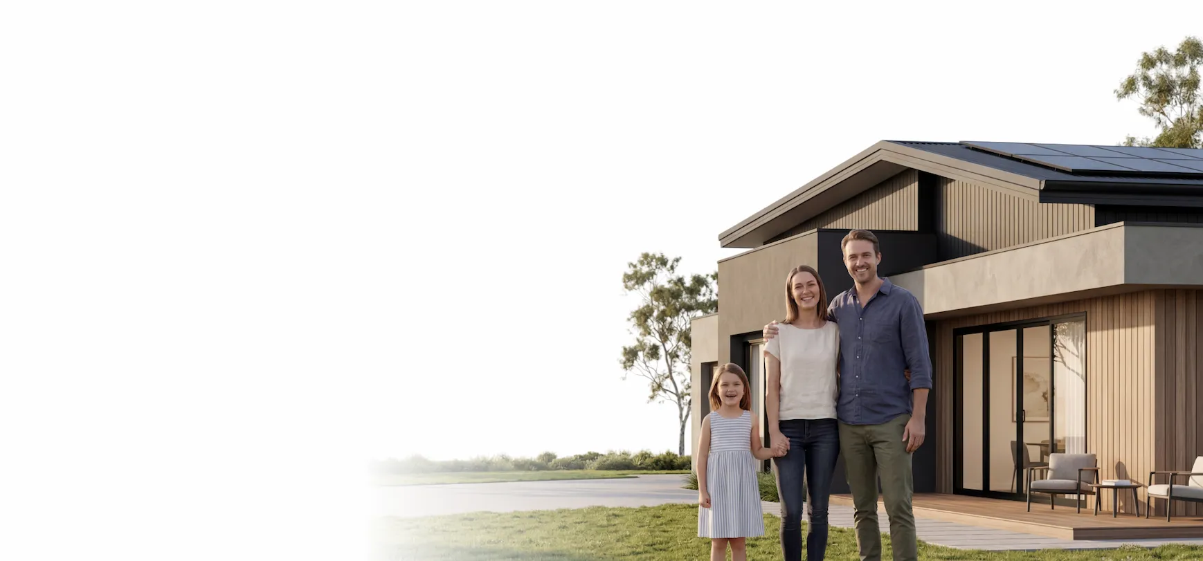 Smiling family of three standing in front of a modern house with solar panels on the roof.