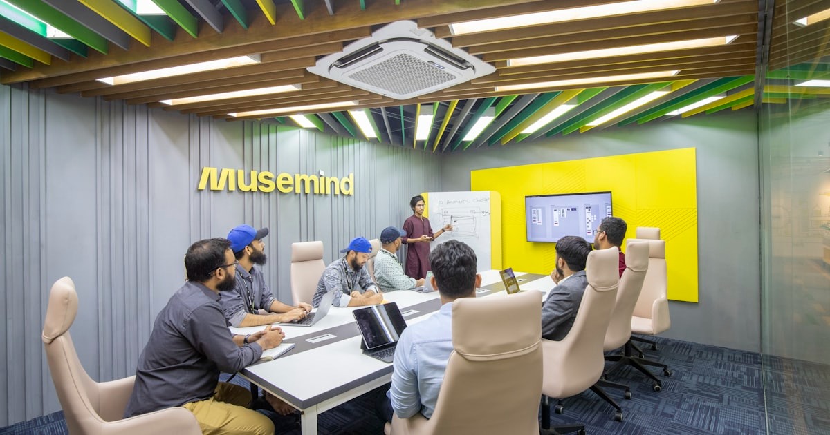 A startup leadership team meeting around a conference table as the company scales past its first management layer.