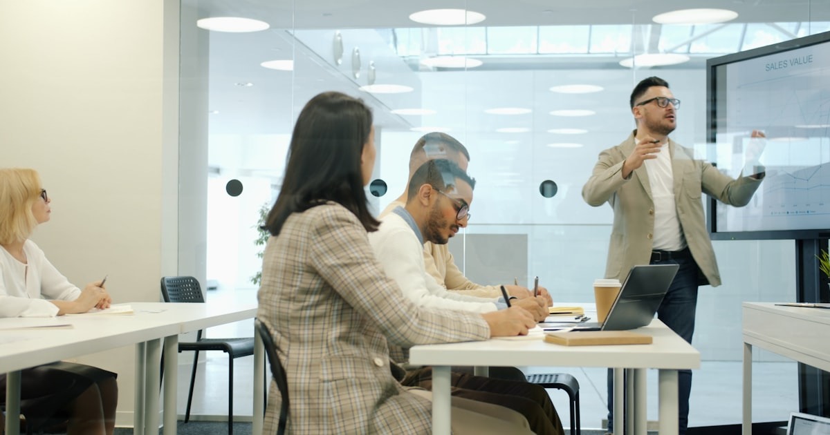 A CEO presenting to an executive team and board in a modern meeting room at the Series C stage.