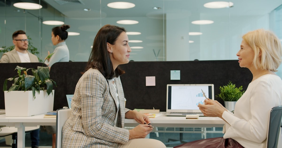 A founder in a focused one-on-one working session at a desk, the developmental, accountability-driven help a coach provides as the company scales.