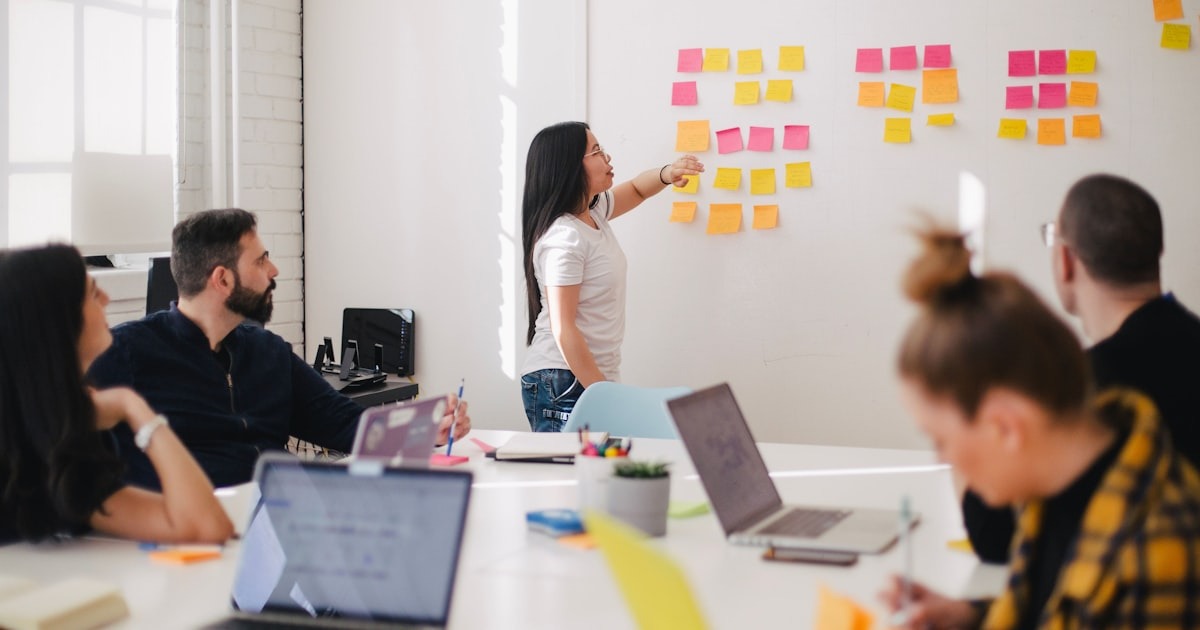 A founder and coach in a focused strategy conversation in a bright office