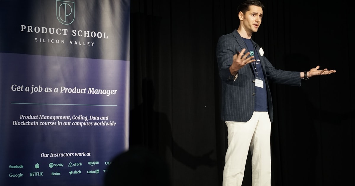 A leader addressing the company at an all-hands meeting on stage