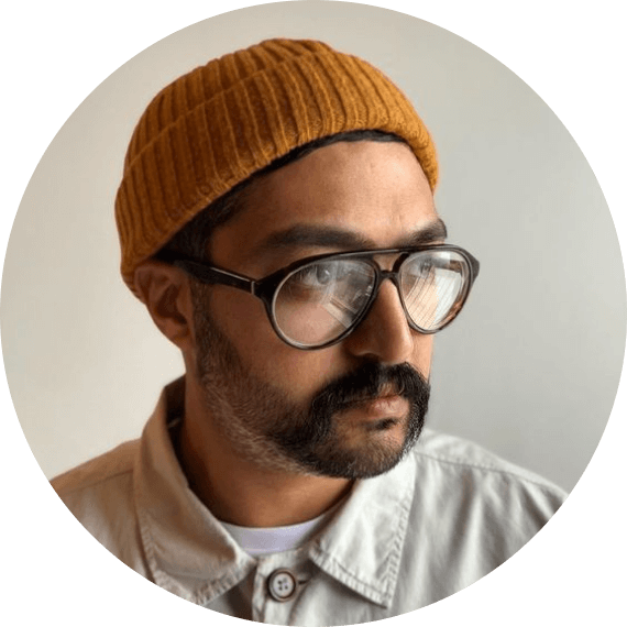 A man wearing glasses and a knitted hat.