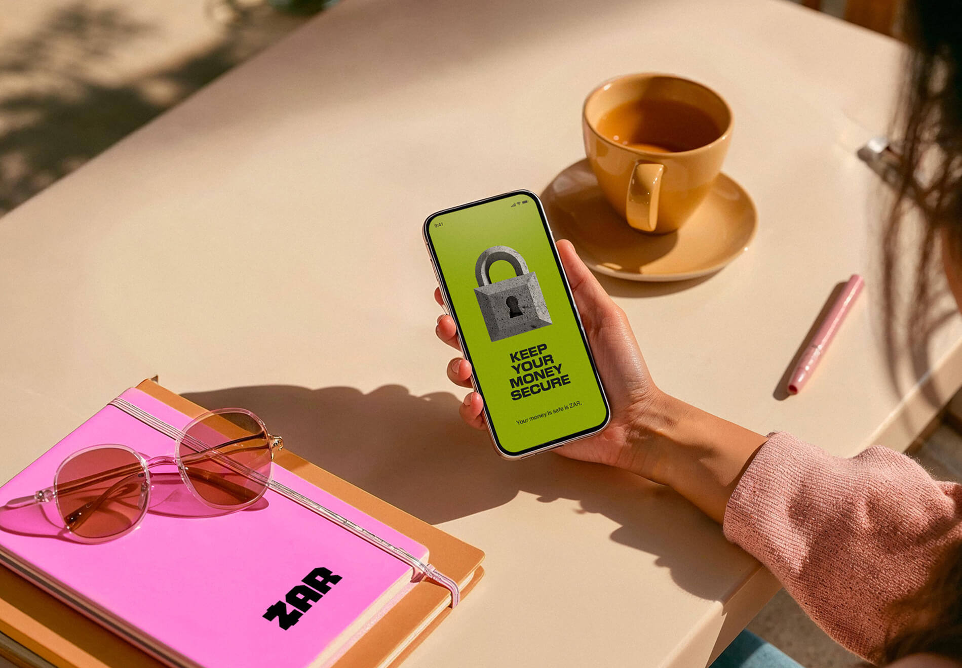 someone holding a phone that shows a lock and the text "keep your money secure"