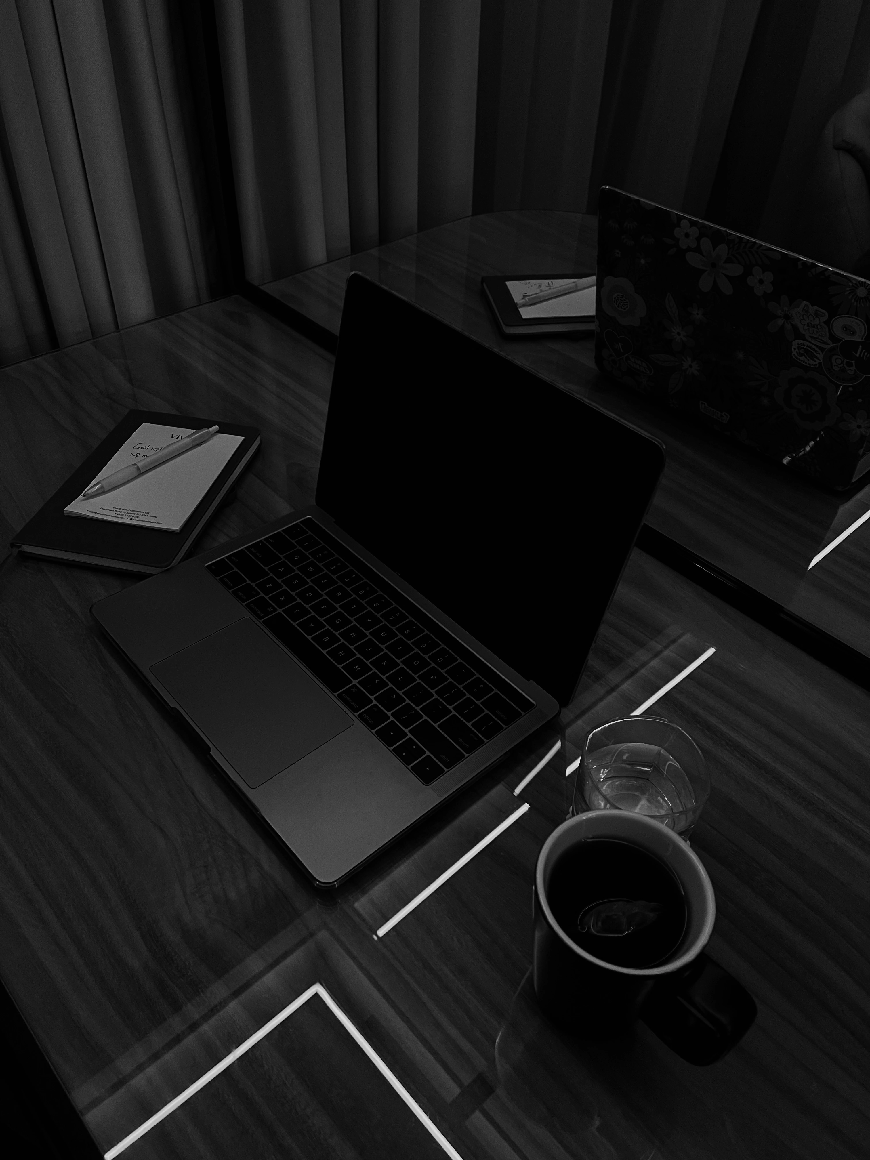 A close up shot of a workstation consisting of tech gadgets like laptop, phone etc