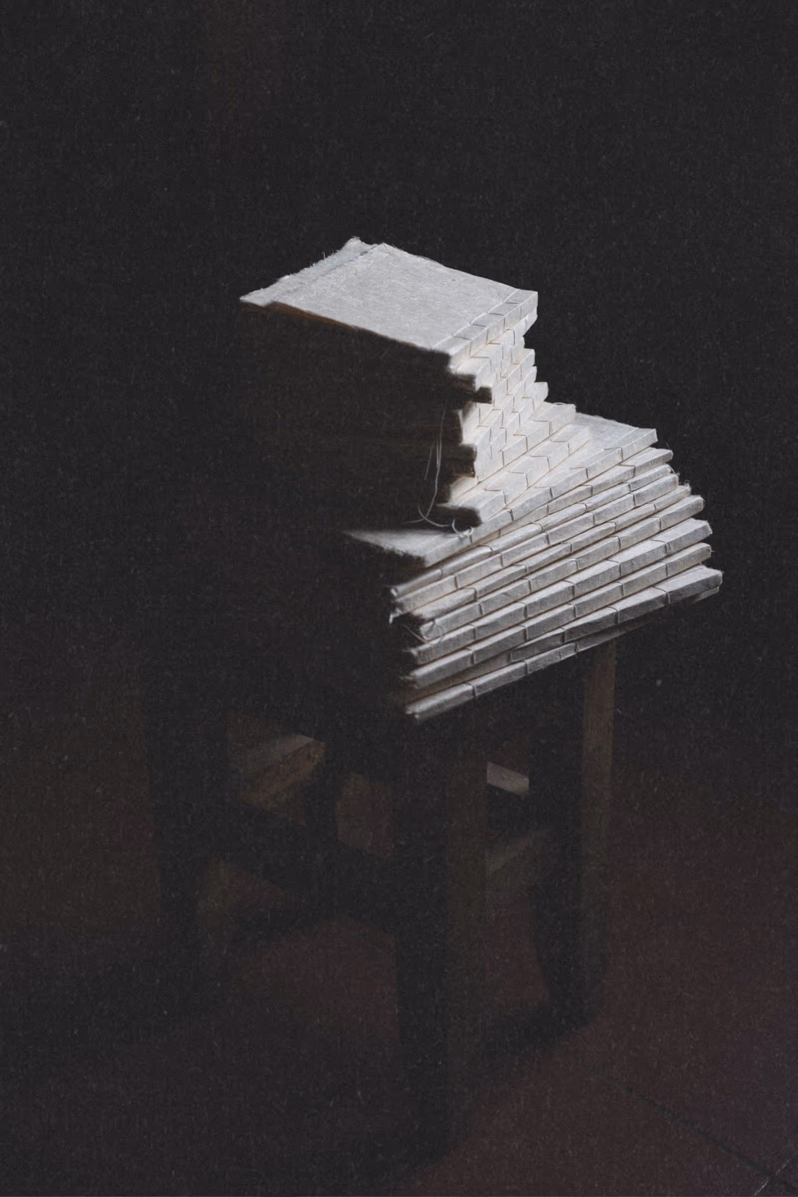 Stack of small handmade journals with varied natural paper textures in old world setting with fine art paper texture overlay.