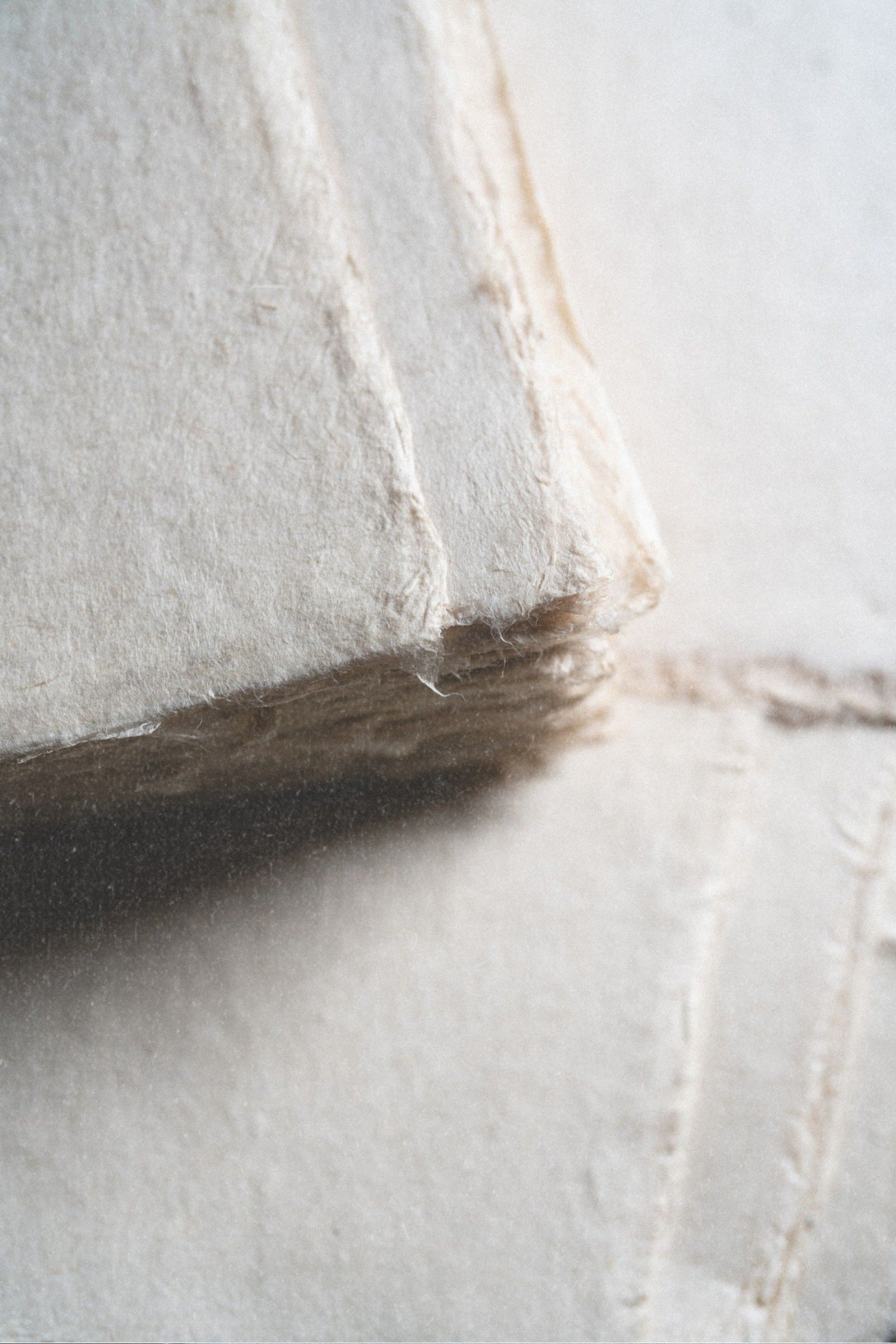 Close-up of hand-crafted deckled edge journal pages showing the quality of natural fibers and subtle texture
