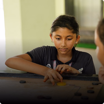 Students playing Carrom