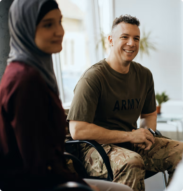 two people are sitting next to eachother and laughing