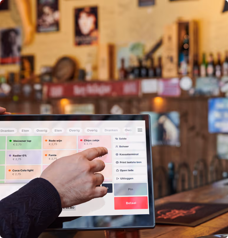 A person tapping the touchscreen of a Twelve point-of-sale system