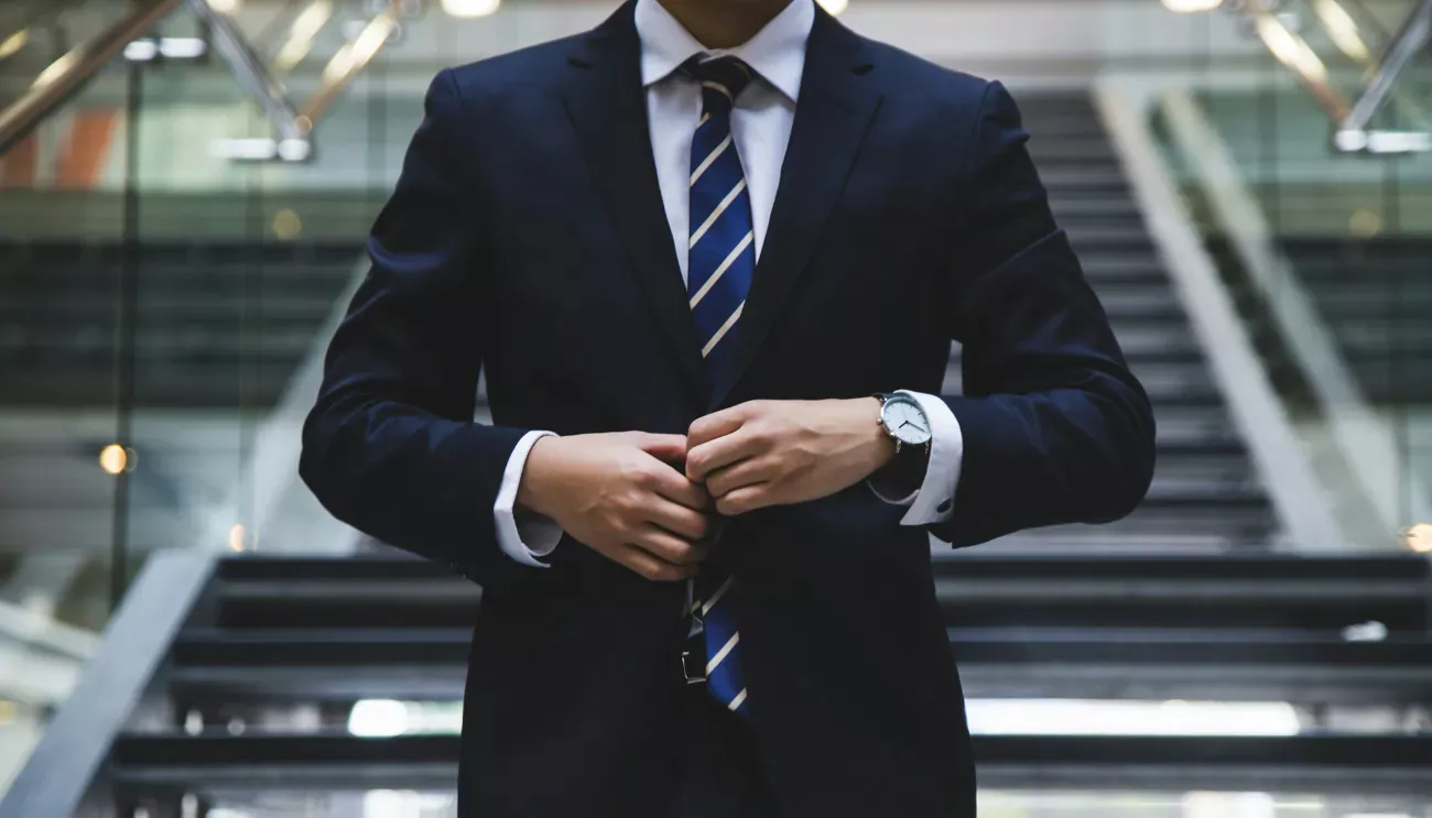 Man buttoning suit jacket