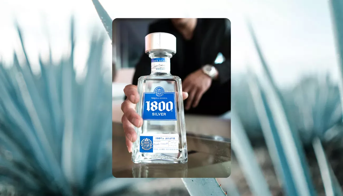 1800 tequila image overlayed in front of another image of agave plants.