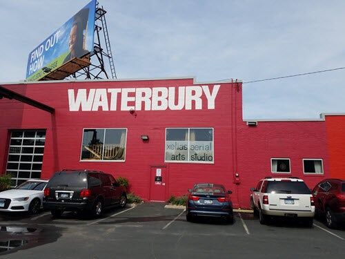 Red building with Waterbury painted in white across the top