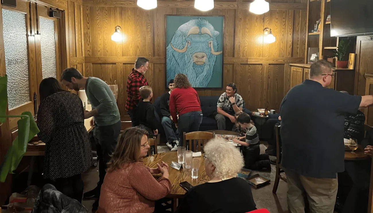 The High Monkey team gathering in a room, enjoying some food.