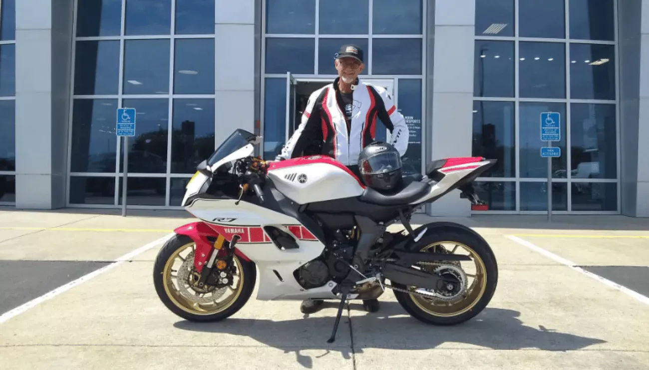 Joel standing with his motorcycle.