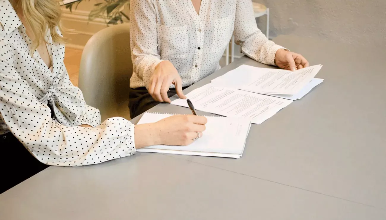 Two people examining a document.
