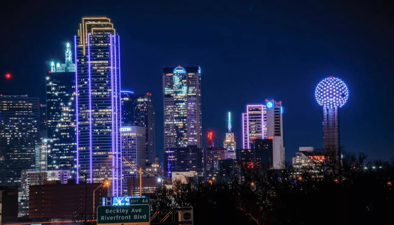 The vibrant night-time skyline of Dallas, Texas.