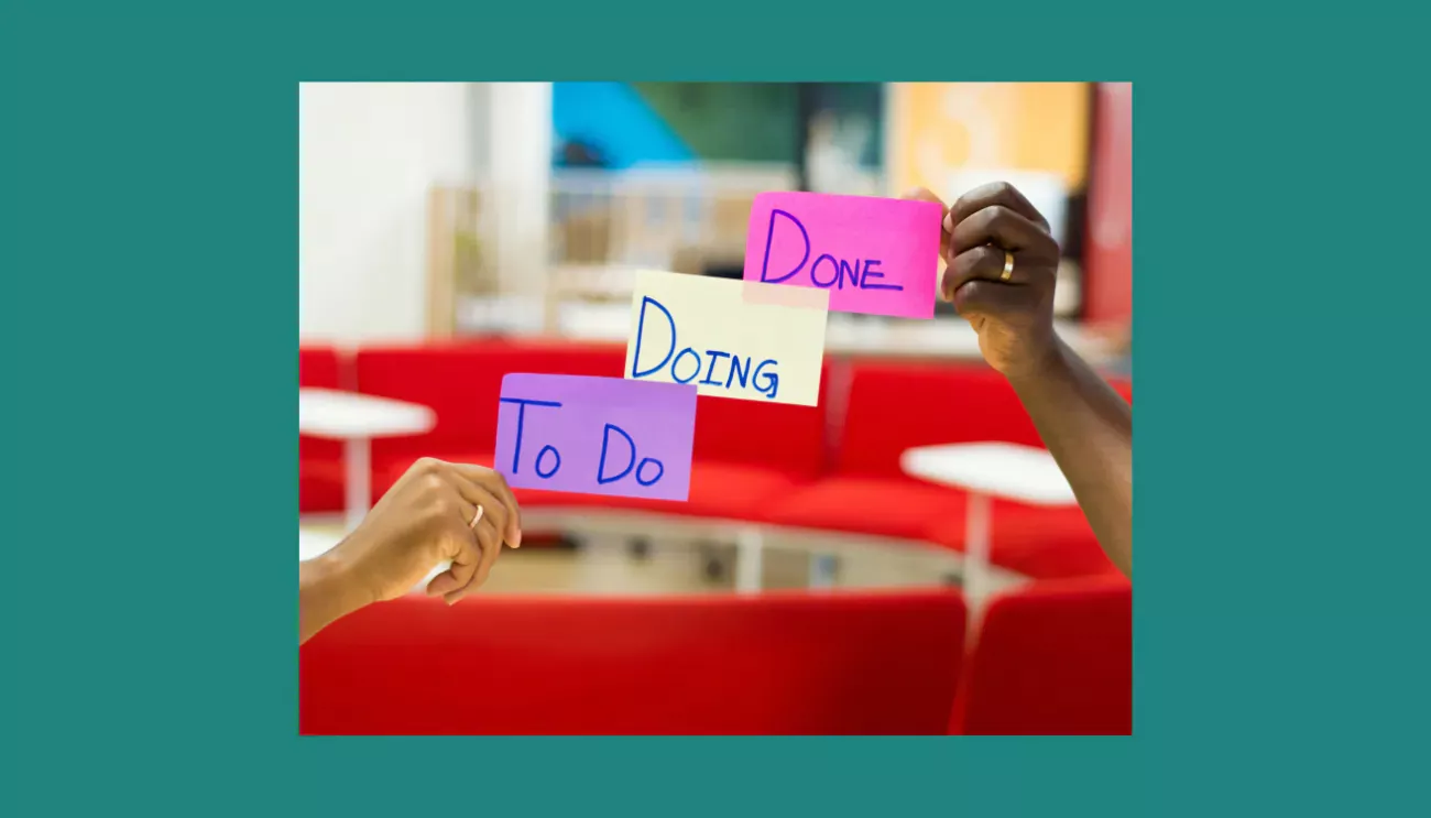 Image showing color-coded 'To Do,' 'Doing,' 'Done' sticky notes in a vibrant office.