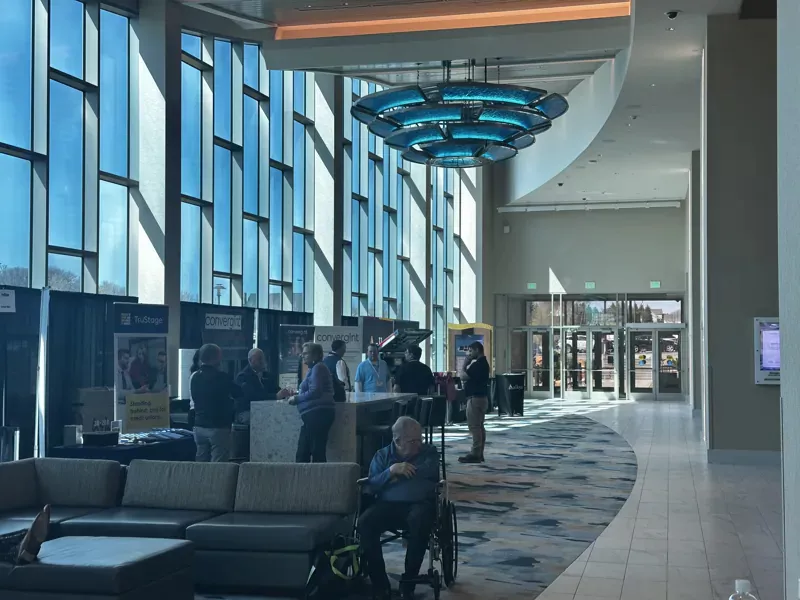 A hall at Accelerate 25 convention with vendor booths.