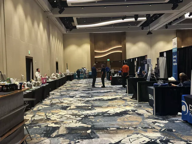 A hall lined with vendor booths at Accelerate 25 convention.