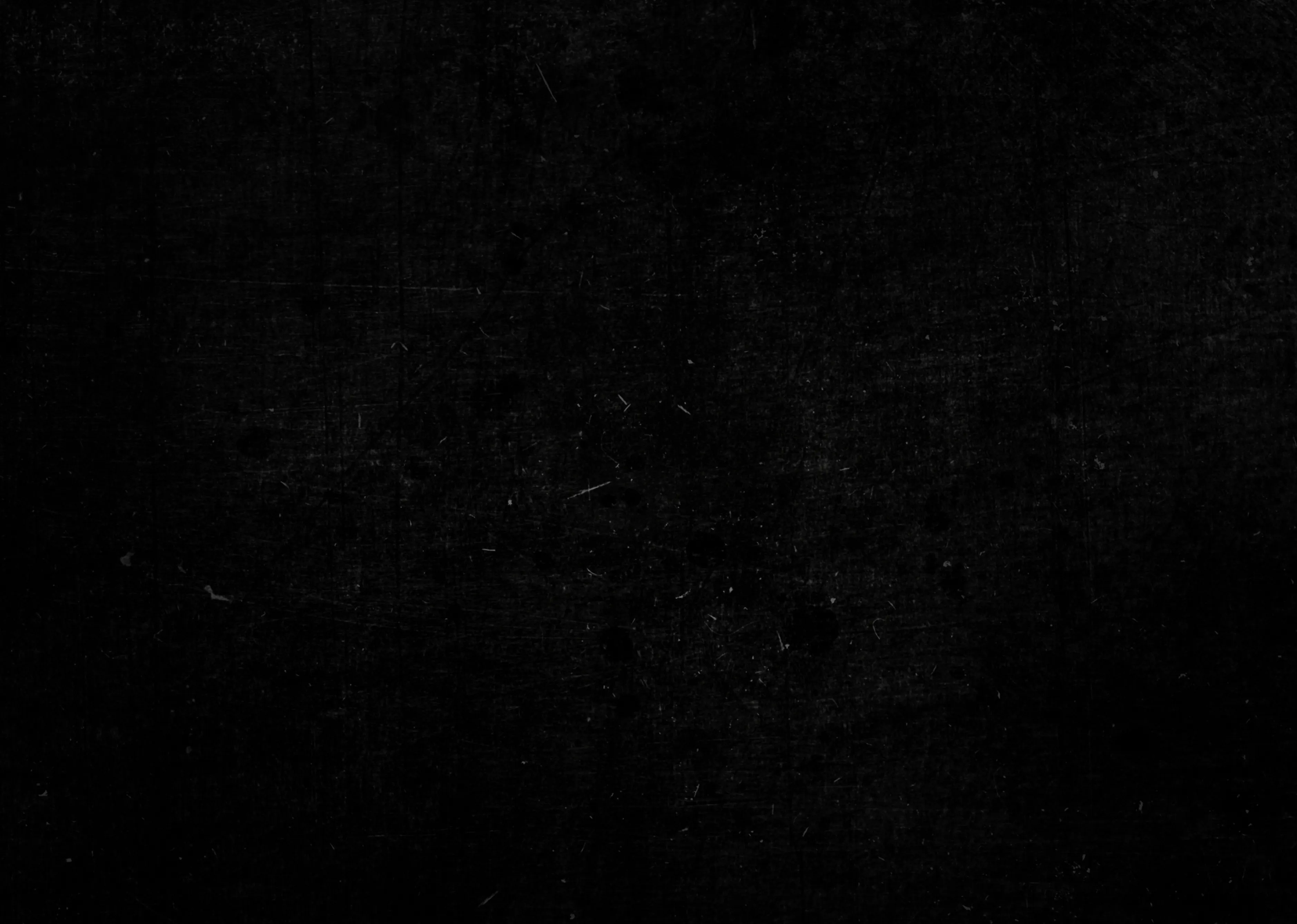 Black textured background with subtle scratches and speckles.