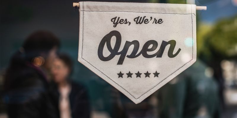 Small business with open sign in the door