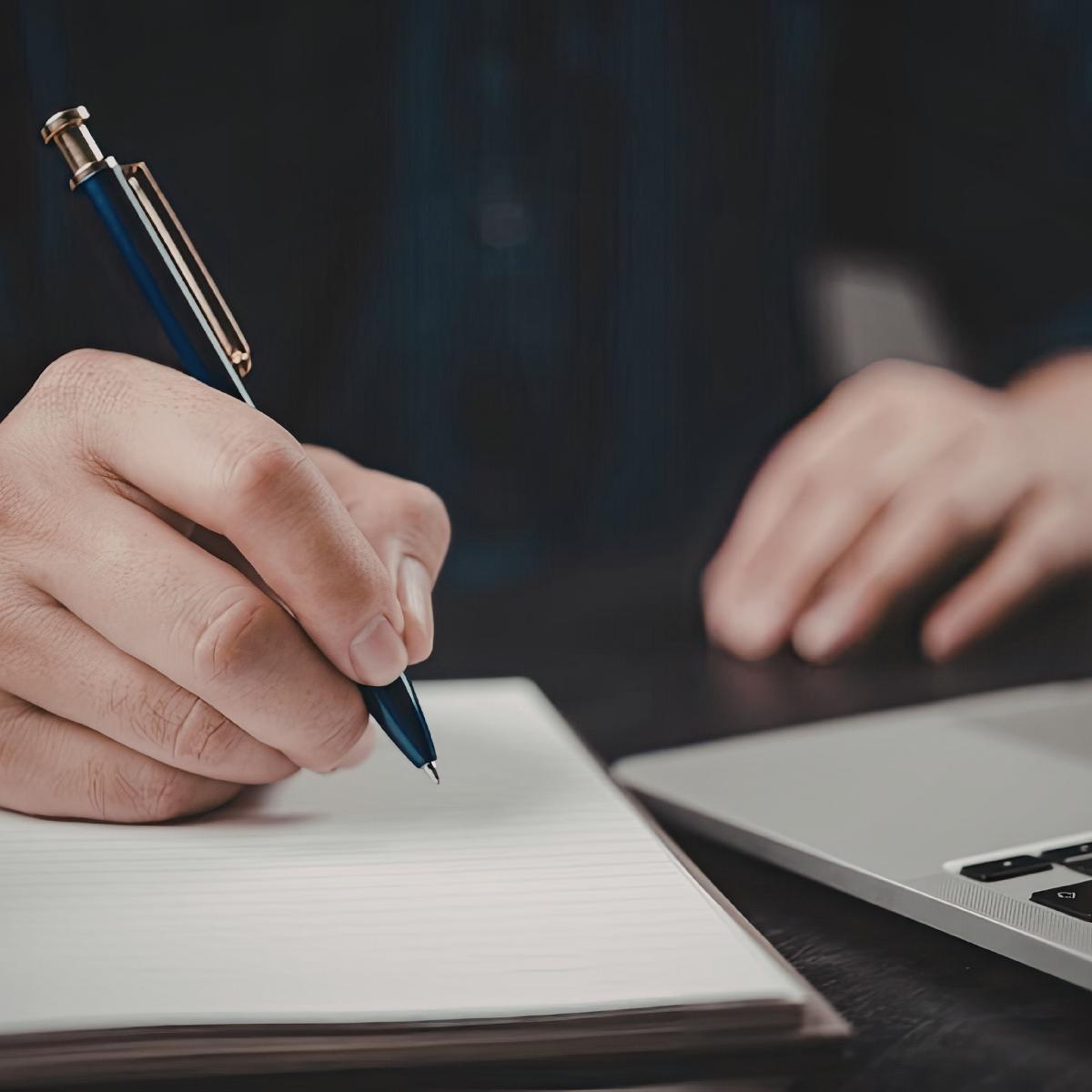 Person planning their estate using pen and paper