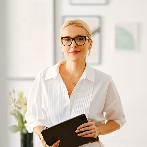 Healthcare professional reviewing patient information with a clipboard