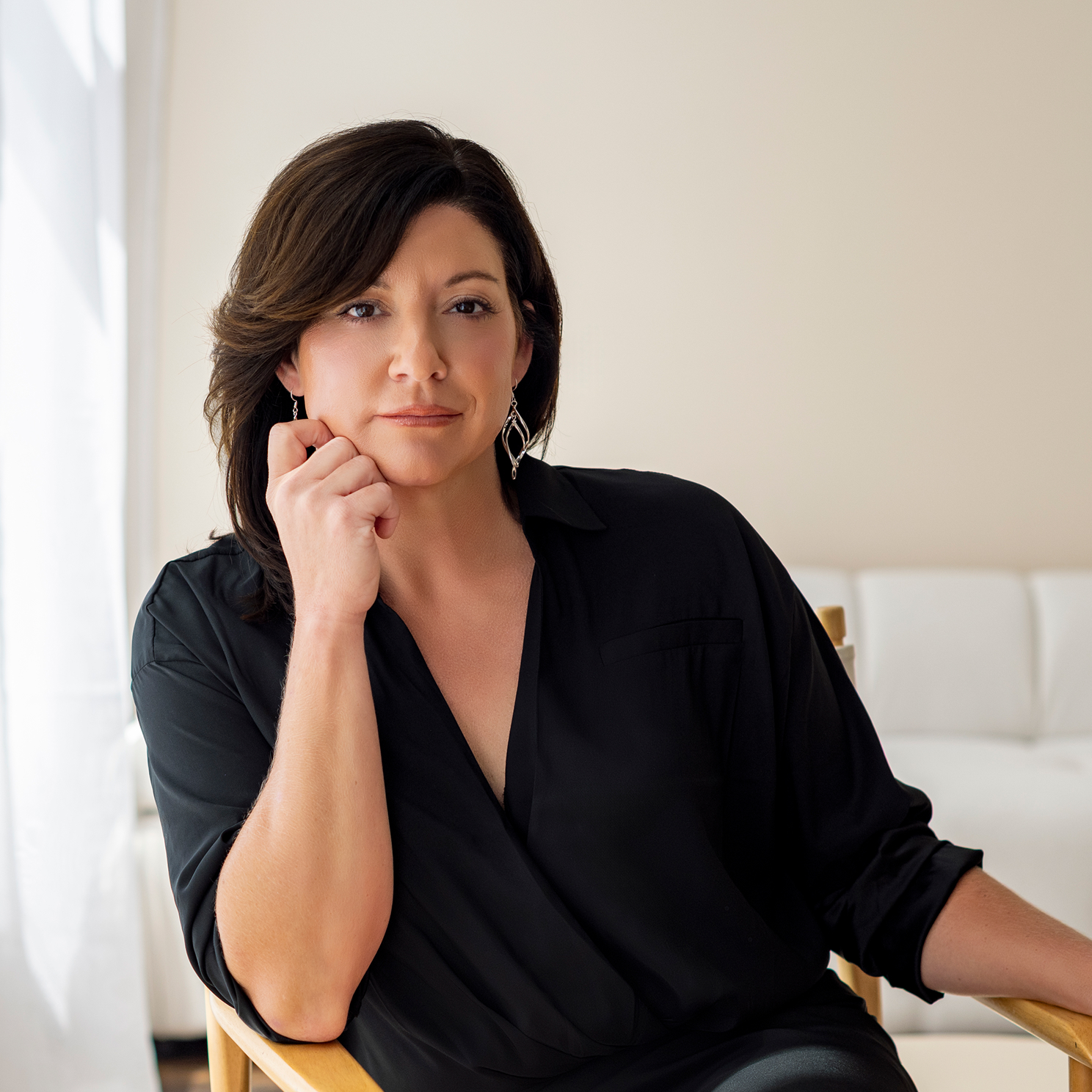 Foxglove founder, Casey Witt, seated and smiling, representing leadership in clinical operations