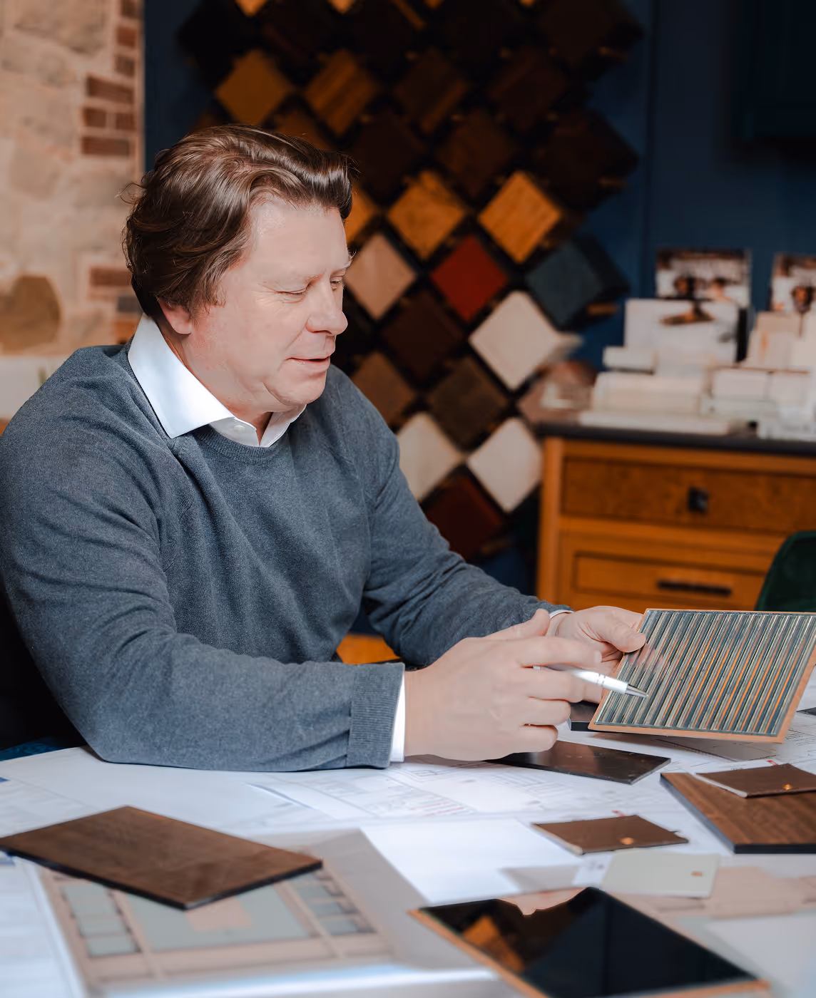 A man sitting at a table with a piece of paper in front of him.