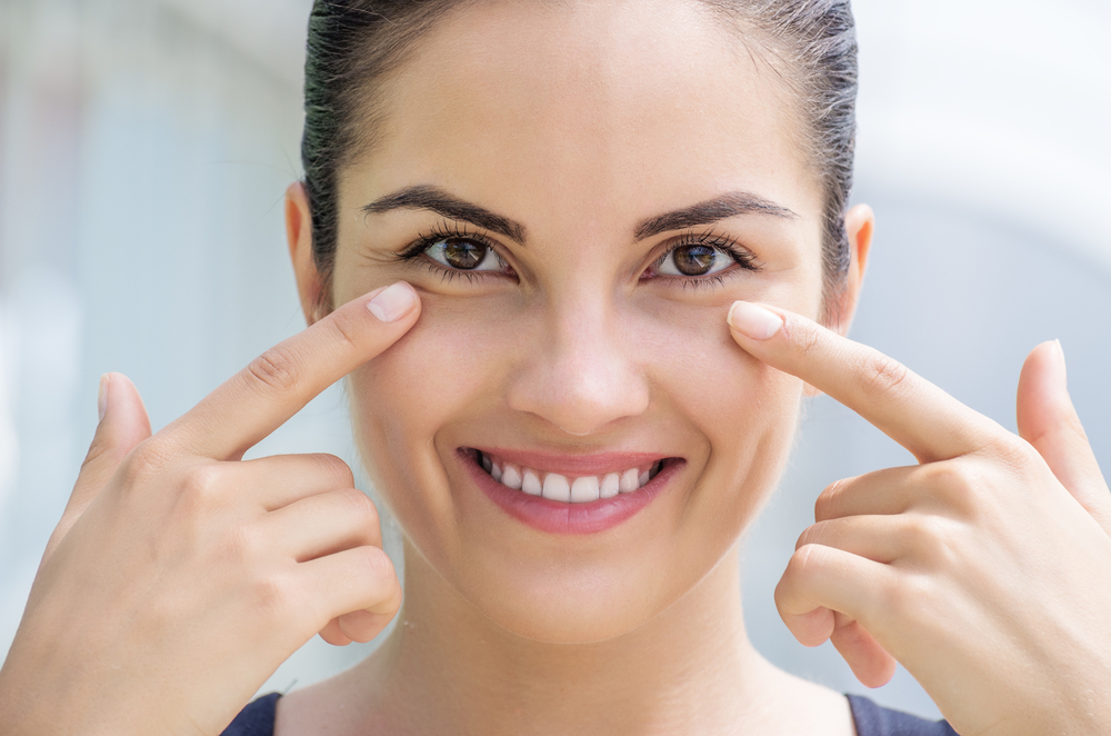 Young woman wearing glasses smiles