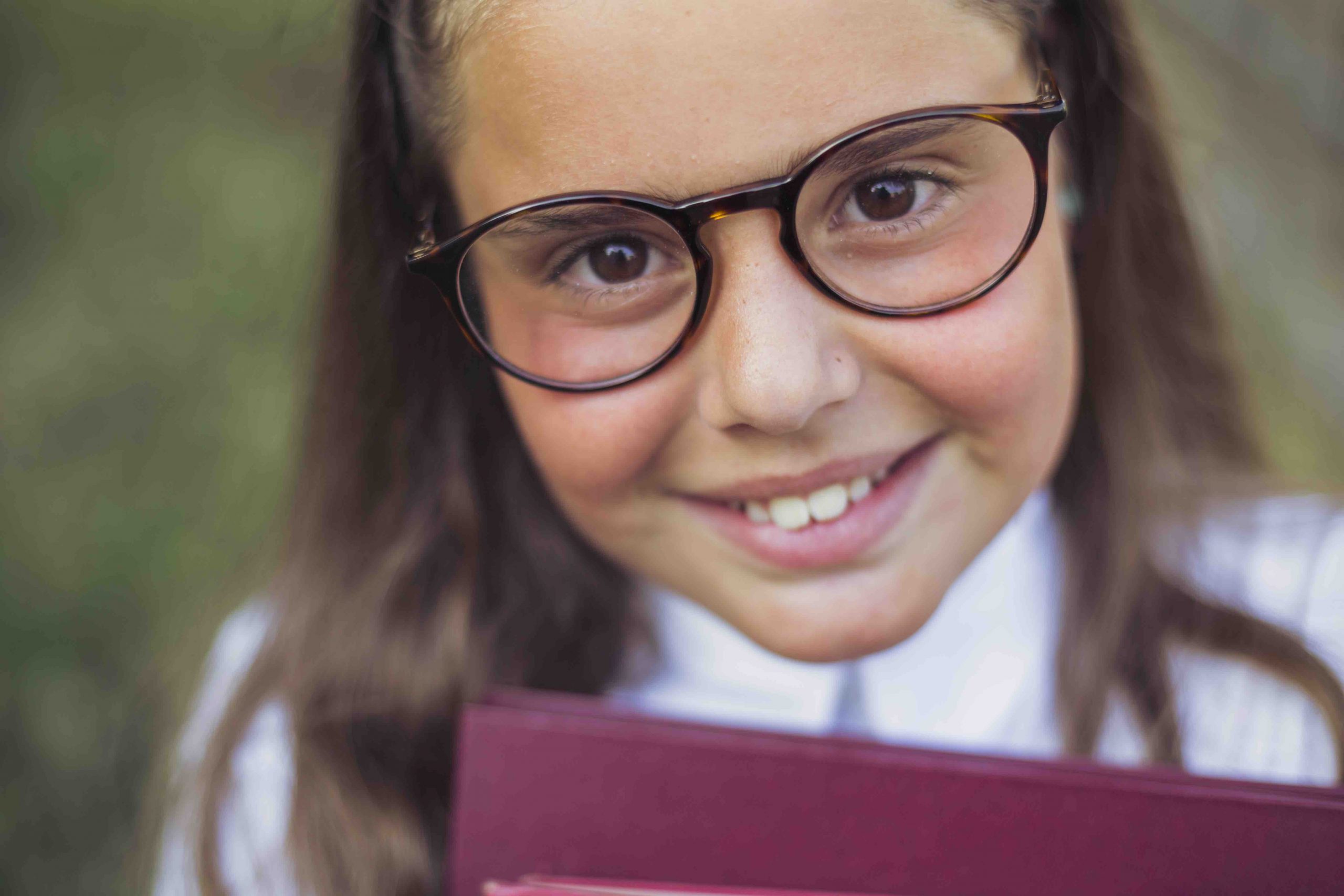 Young woman wearing glasses smiles