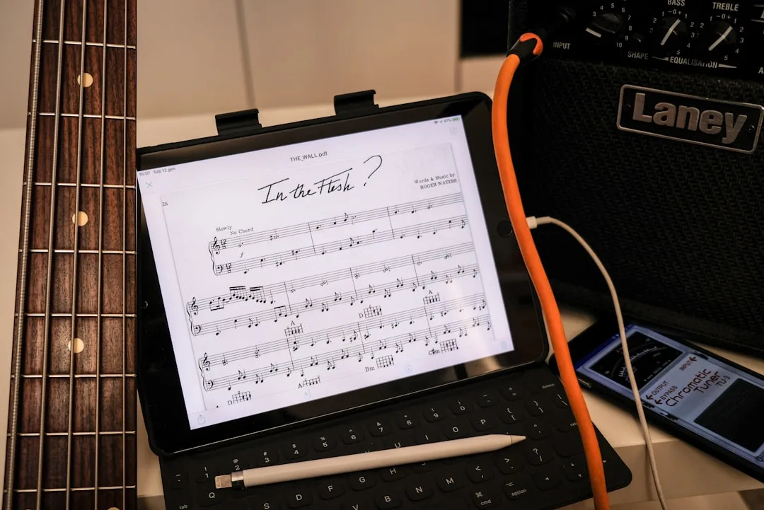 A musician annotating a digital sheet music score on an iPad with a stylus