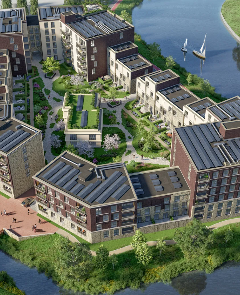 Radiance Visual. Aerial view of a modern residential complex with multiple buildings featuring solar panels on the roofs, landscaped green spaces, walking paths, and a river with two sailboats nearby.