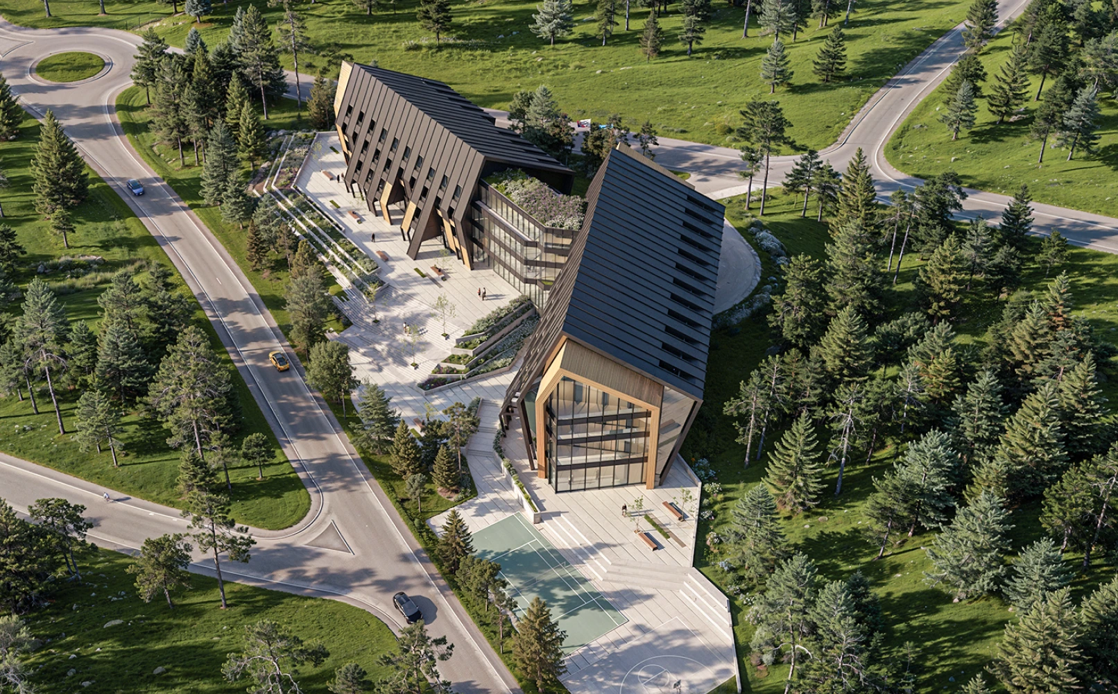 Radiance Visual. Aerial view of two modern black-roofed buildings surrounded by trees with adjacent roads and a basketball court in a green park setting.