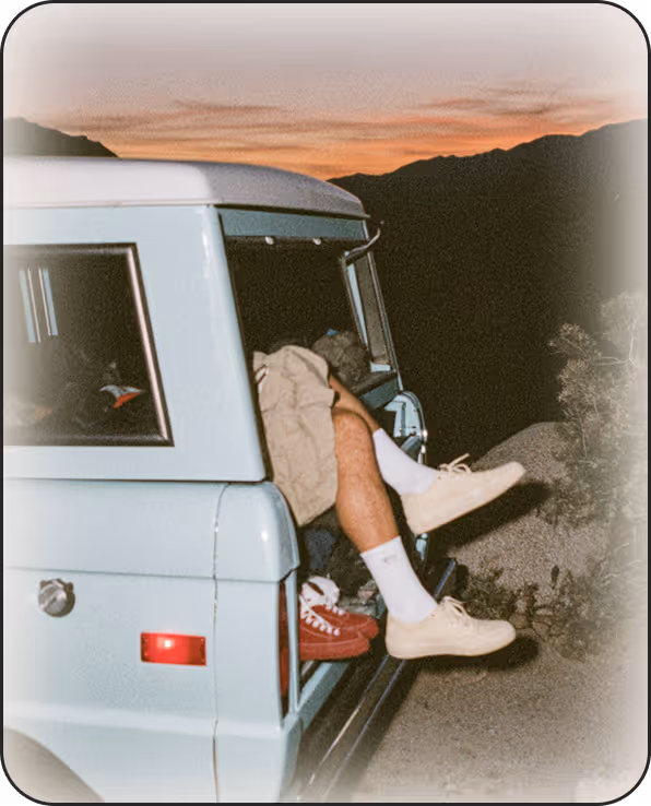 A man sitting in the back of a blue truck.