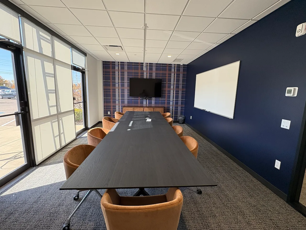 Branded conference room with glass doors at Power HRG’s Cincinnati office, built by Oswald Company.