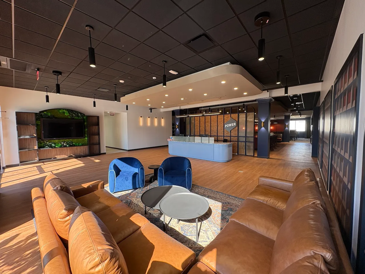 Lobby and collaboration lounge at Power Home Remodeling Group’s Cincinnati regional office, featuring modern finishes and open gathering spaces built by Oswald Company.