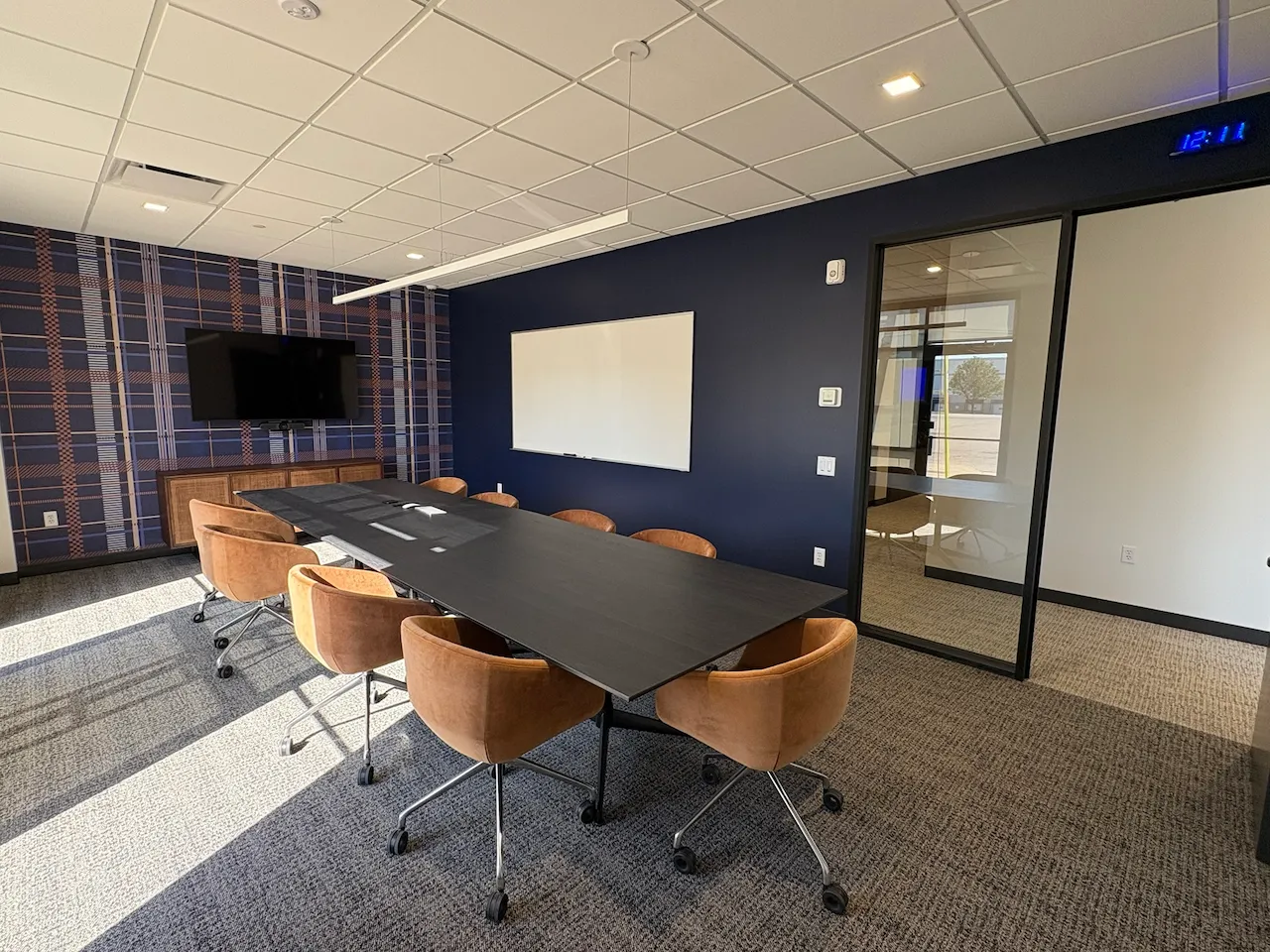 Branded conference room with glass doors at Power HRG’s Cincinnati office, built by Oswald Company.