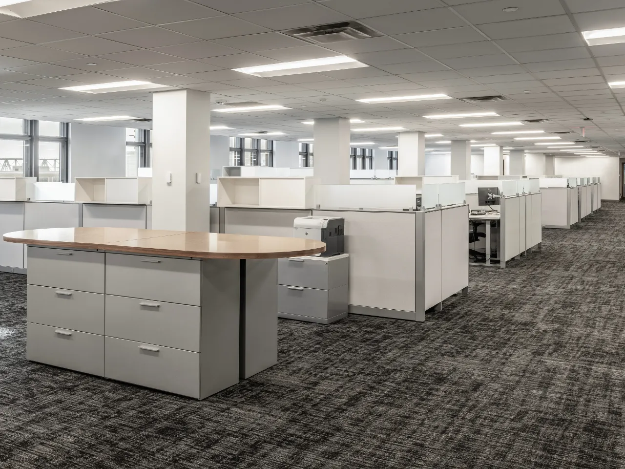 Open office workspace at the David J. Joseph Company headquarters featuring new carpeting, drop ceilings, and custom millwork completed by Oswald Company.