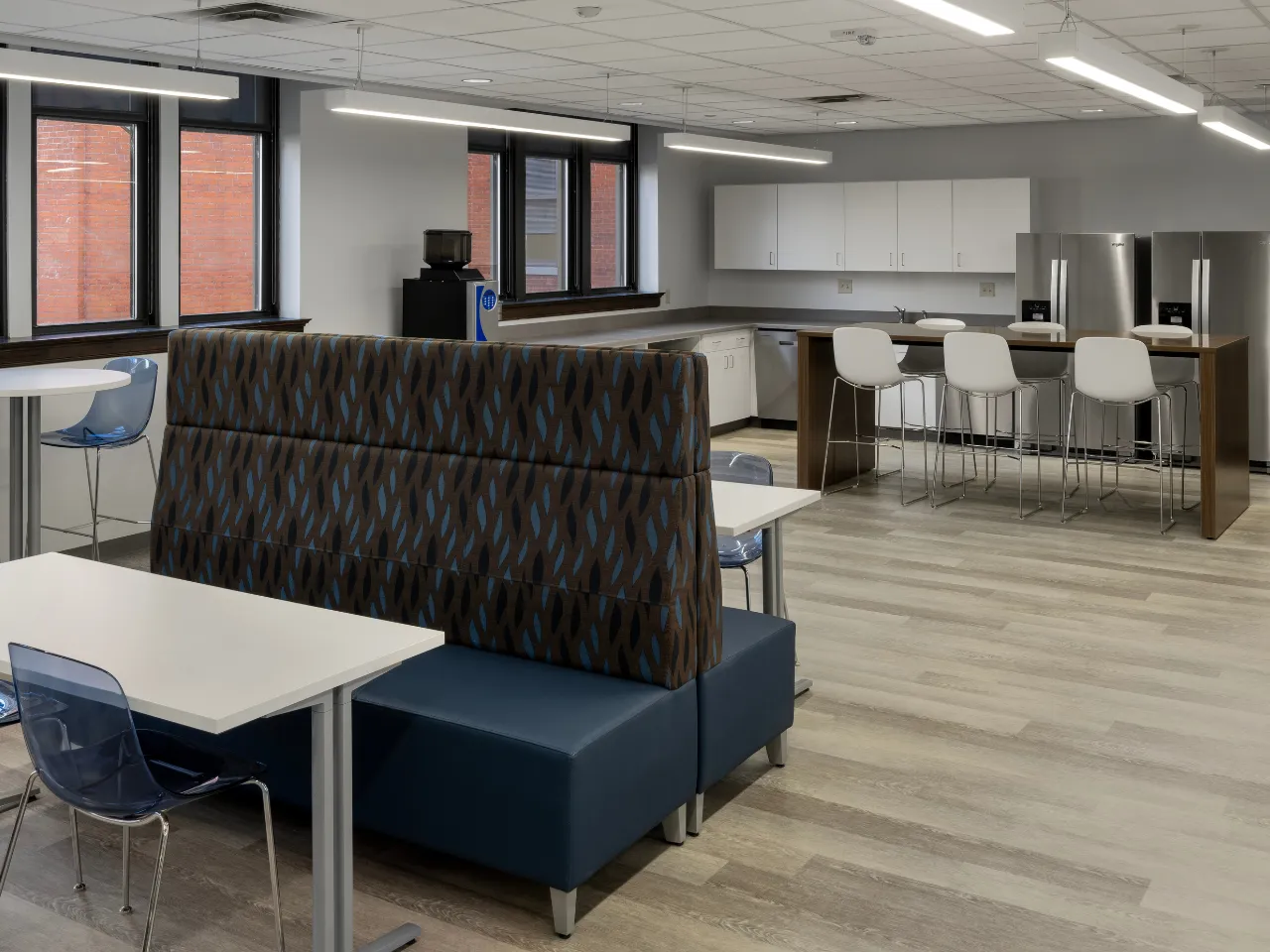 Contemporary seating and kitchen area by Oswald Company.