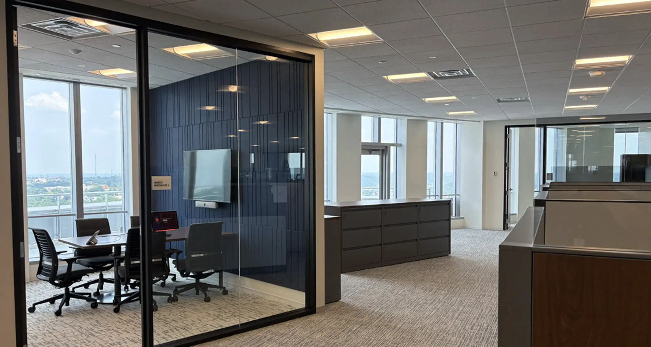 Glass door conference room in open space office  by Oswald Company.