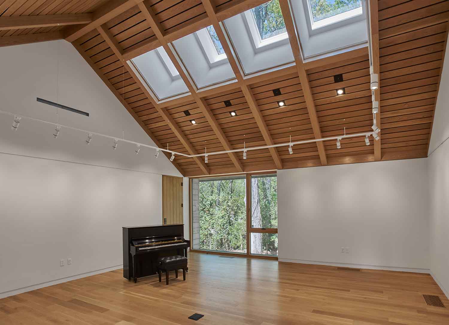 Music room with vaulted wooden ceilings at the Loghaven Gateway Building and Artist Studios by Johnson & Galyon.