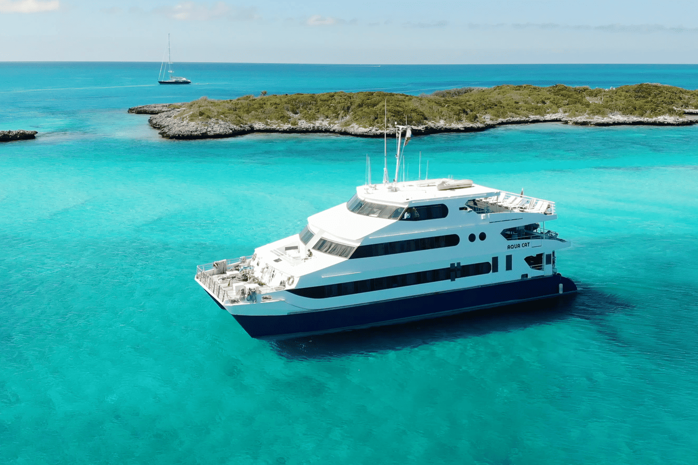 The Aqua Cat liveaboard anchored near a beach, Bahamas